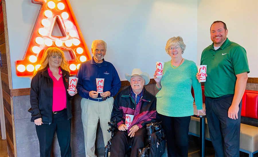 Mayor Hall, Councilmembers Winters and Duffy, Vice Mayor Cline and Arby's Area Supervisor Arletter Murray holding Arby's cups.