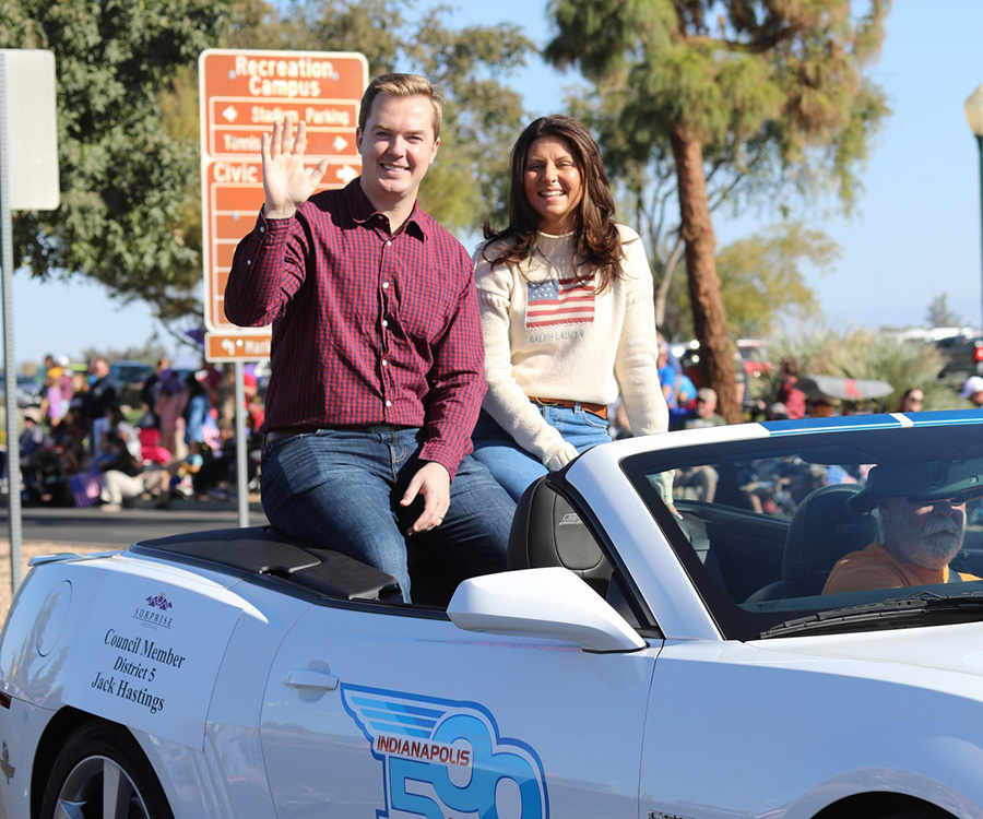 Councilmember Hastings and his wife posing for a picture in a convertible car