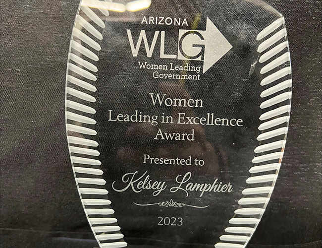 A glass award with text printed on it.