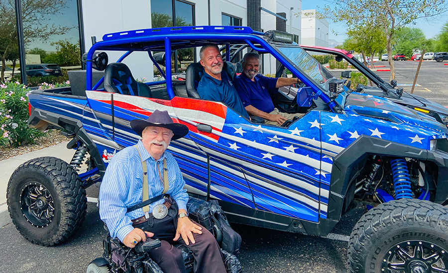 Mayor Hall and Councilmembers in a blue UTV