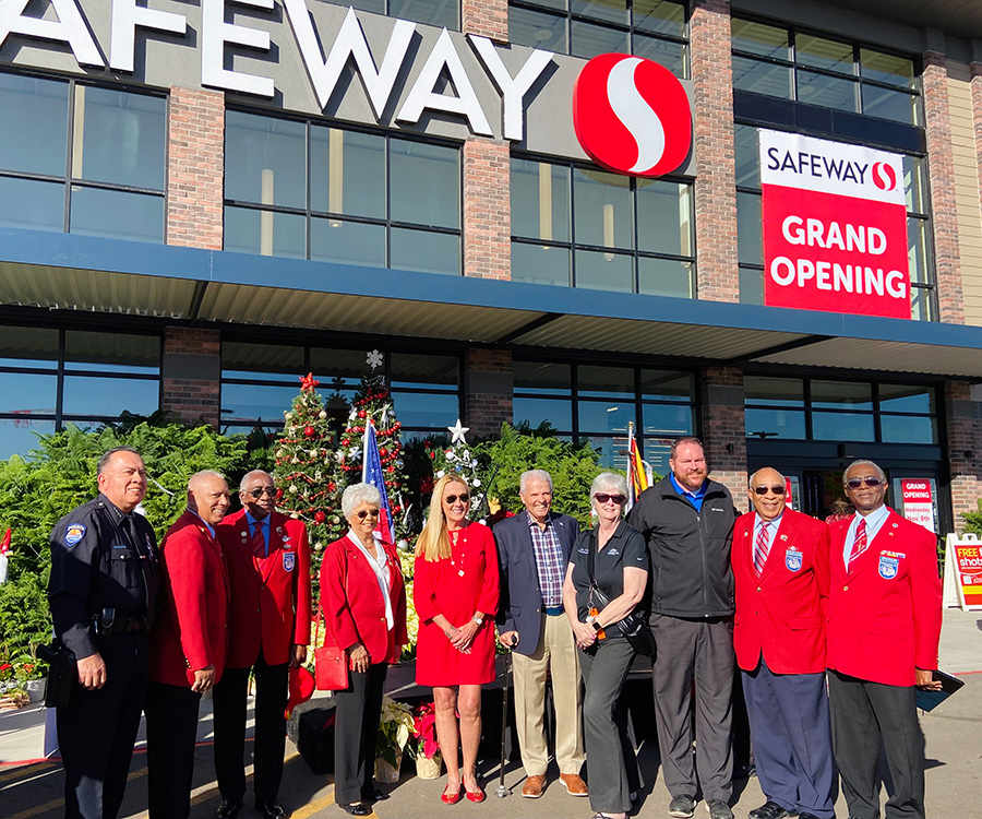 A group of people including Mayor Hall, Councilmembers Cline and Duffy, and Police Chief Pina posing for a photo in front of Safeway