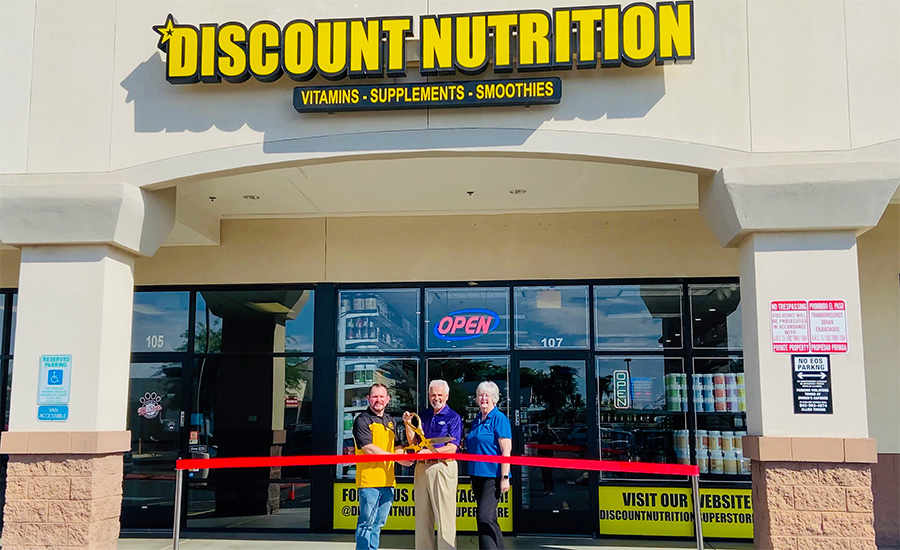 Mayor Hall and Vice Mayor Cline cut a grand opening ribbon outside of Discount Nutrition.
