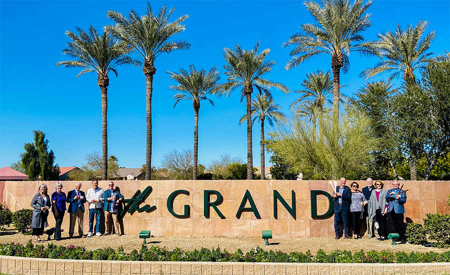 Vice Mayor Judd, Councilmember Cline, Bob Aiken and Rene Mitchell standing in front of the new sign for The Grand.